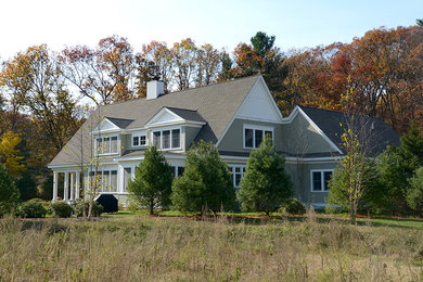 Example of a large classic green two-story wood exterior home design in Boston