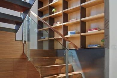 Photo of a large modern wood u-shaped staircase in San Francisco with open risers and wood railing.