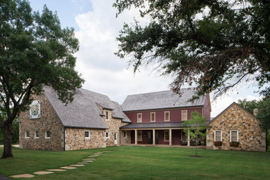 Large farmhouse multicolored two-story wood and clapboard exterior home photo in Dallas with a mixed material roof and a gray roof