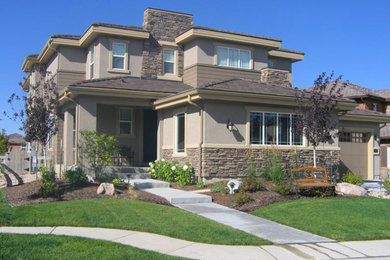 This is an example of a mid-sized traditional drought-tolerant and full sun backyard water fountain landscape in Denver.