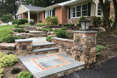 Inspiration for a mid-sized traditional front yard partial sun formal garden for summer in Baltimore with a garden path and natural stone pavers.