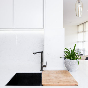 Modern White Kitchen with Waterfall Benchtops