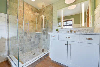 Inspiration for a contemporary master brown floor, single-sink and wainscoting corner shower remodel in Philadelphia with recessed-panel cabinets, green walls, a hinged shower door and a built-in vanity
