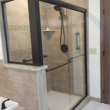 Semi-framed, sliding shower door with oil rubbed bronze hardwear.