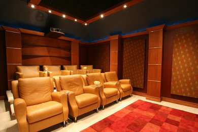 Photo of a mid-sized contemporary enclosed home theatre in Dallas with red walls, carpet and a projector screen.
