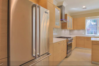 Inspiration for a mid-sized timeless l-shaped eat-in kitchen remodel in New York with glass-front cabinets and an island