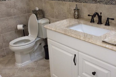 Inspiration for a beige tile and ceramic tile corner shower remodel in New York