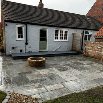 Whole Cottage Yard Paved Around a Brick Fire Pit