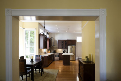 Eat-in kitchen - transitional l-shaped eat-in kitchen idea in San Francisco with an undermount sink, recessed-panel cabinets, dark wood cabinets, quartz countertops, beige backsplash and stainless steel appliances