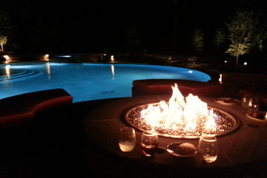 Inspiration for a large timeless backyard stone patio remodel in Raleigh with a fire pit