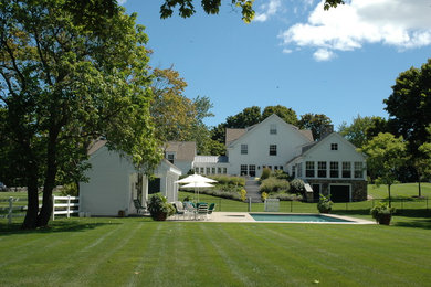 Inspiration for a large timeless white two-story mixed siding exterior home remodel in Boston with a shingle roof