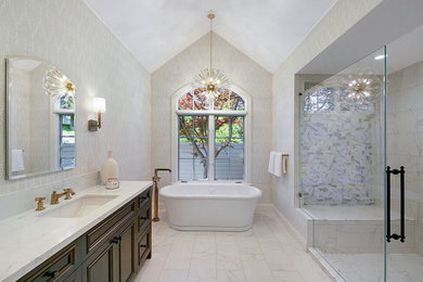 Bathroom - large transitional master white tile and marble tile marble floor, white floor, double-sink, vaulted ceiling and wallpaper bathroom idea in San Francisco with recessed-panel cabinets, dark wood cabinets, a two-piece toilet, beige walls, an undermount sink, quartz countertops, a hinged shower door, white countertops and a built-in vanity