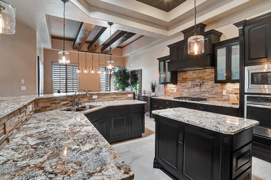 Inspiration for a large transitional ceramic tile eat-in kitchen remodel in Austin with a double-bowl sink, recessed-panel cabinets, black cabinets, granite countertops, brown backsplash, stone tile backsplash, stainless steel appliances and an island
