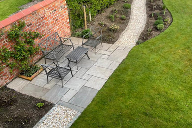Medium sized rural back partial sun garden seating in Other with natural stone paving.