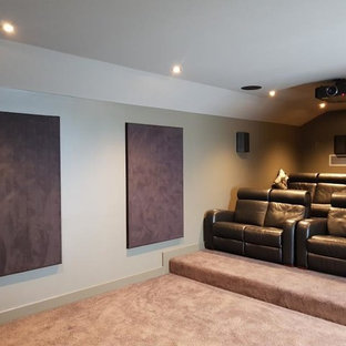 Design ideas for a medium sized modern enclosed home cinema in Adelaide with green walls, carpet, a projector screen and brown floors.