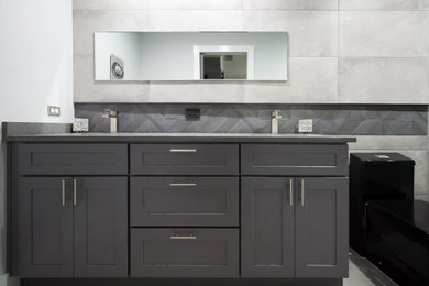 Photo of a mid-sized contemporary bathroom in Dallas with shaker cabinets, grey cabinets, an alcove shower, a one-piece toilet, porcelain tile, grey walls, porcelain floors, an undermount sink, engineered quartz benchtops, a sliding shower screen, grey benchtops, a double vanity and a freestanding vanity.