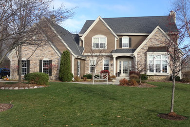 Example of a mid-sized minimalist brown two-story wood gable roof design in Milwaukee
