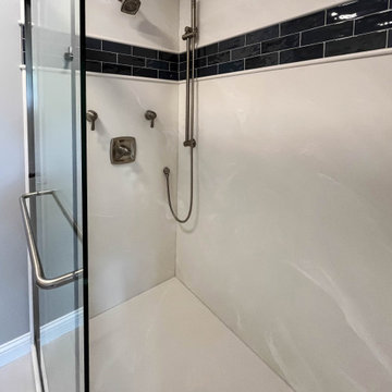 Primary Bathroom with Blue-Gray Vanity and Deep Blue Tiled Feature Wall