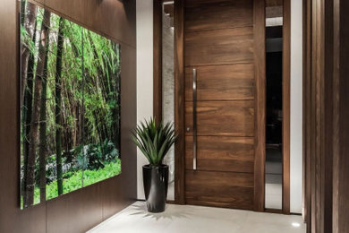 Entryway - large modern porcelain tile, white floor, wood ceiling and wall paneling entryway idea in Miami with brown walls and a medium wood front door