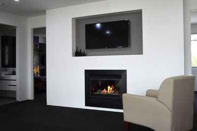 Photo of a mid-sized modern living room in Sydney with a library, a brick fireplace surround and a built-in media wall.