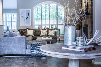Inspiration for a transitional porcelain tile and gray floor living room remodel in Austin with a stone fireplace