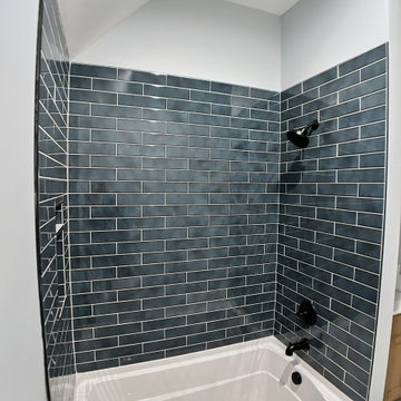 Elegant Guest Bath: Soft Terracotta Walls, Marble Vanity, and Modern Black Fixtu