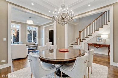 Mid-sized minimalist medium tone wood floor and brown floor enclosed dining room photo in Chicago with brown walls