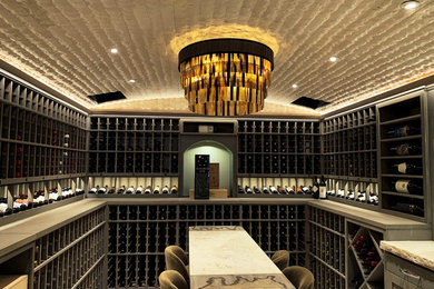 Photo of a large wine cellar in San Luis Obispo with limestone floors and storage racks.