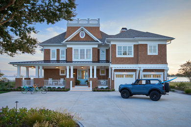 Huge beach style orange three-story vinyl and shingle house exterior photo in Baltimore