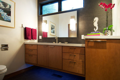 Powder room - mid-sized contemporary gray tile and porcelain tile porcelain tile powder room idea in Seattle with an undermount sink, flat-panel cabinets, marble countertops, a wall-mount toilet, white walls and medium tone wood cabinets