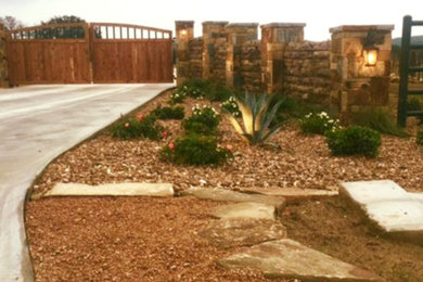This is an example of a large rustic full sun front yard gravel driveway in Dallas.