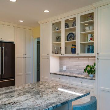 Modern Kitchen With White Painted Shaker Style Cabinets With a Bevel
