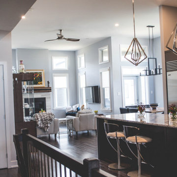 View of the Great Room, Dining Room, and Kitchen from the front entrance