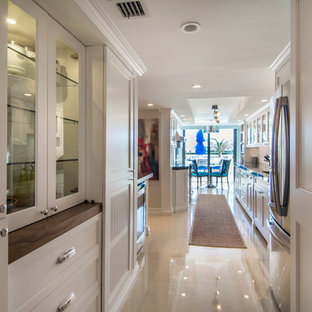 Large transitional kitchen pantry photos - Kitchen pantry - large transitional galley marble floor and beige floor kitchen pantry idea in Miami with an undermount sink, beaded inset cabinets, white cabinets, quartzite countertops, white backsplash, marble backsplash, stainless steel appliances and no island