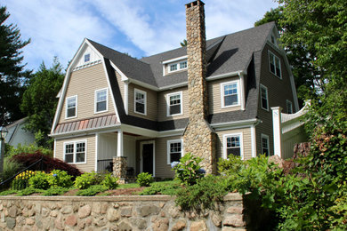 Example of a mid-sized arts and crafts beige three-story mixed siding and board and batten house exterior design in Boston with a gambrel roof and a mixed material roof