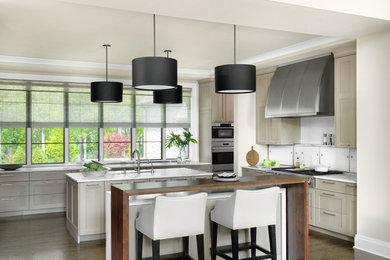 Inspiration for a transitional dark wood floor kitchen remodel in St Louis with an undermount sink, recessed-panel cabinets, light wood cabinets, quartz countertops, white backsplash, glass tile backsplash, stainless steel appliances, two islands and white countertops