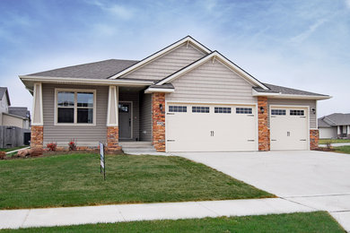 Mid-sized craftsman gray two-story mixed siding exterior home idea in Other with a hip roof