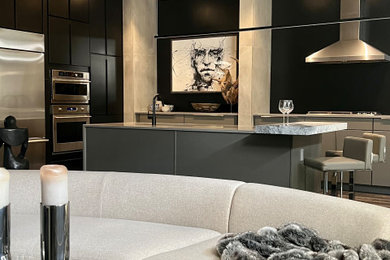 Minimalist dark wood floor and brown floor enclosed kitchen photo with an undermount sink, flat-panel cabinets, black cabinets, quartz countertops, black backsplash, stainless steel appliances, an island and gray countertops