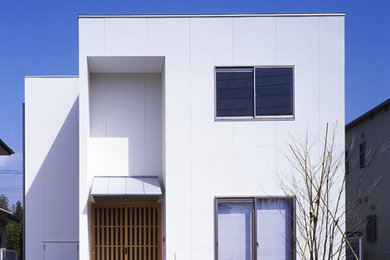 Modern two-storey white exterior in Osaka with a flat roof.