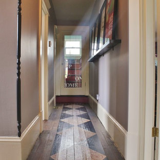 Inspiration for a small eclectic hallway in Seattle with purple walls and painted wood floors.