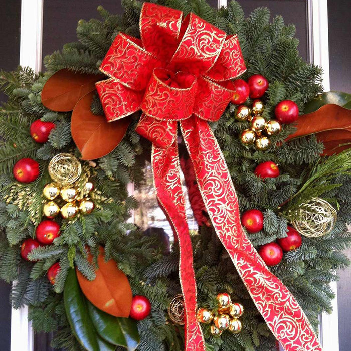 hand made decorative wreiath with spruce bows, berry, magnolia, berries and festive hand tied bow. Peter Atkins and Associates.,LLC