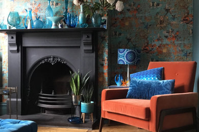 This is an example of a medium sized retro living room feature wall in Other with blue walls, medium hardwood flooring and wallpapered walls.