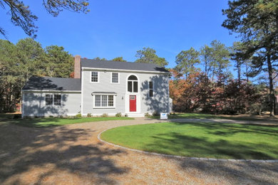 Large elegant gray two-story wood exterior home photo in Boston with a shingle roof