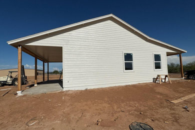 Small cottage white one-story wood and clapboard exterior home idea in Phoenix with a shingle roof and a black roof
