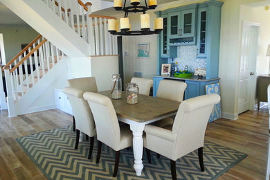 Mid-sized beach style medium tone wood floor great room photo in New York with yellow walls and no fireplace