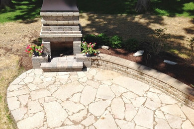 Design ideas for a traditional backyard patio in Chicago with a fire feature and natural stone pavers.