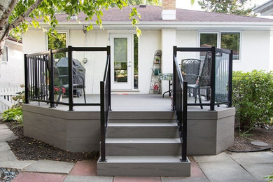 Mid-sized elegant backyard deck photo in Other with no cover