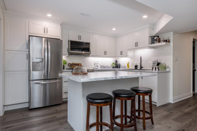 Basement - modern walk-out vinyl floor basement idea in Toronto