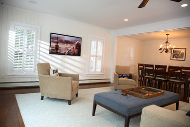 Transitional family room photo in Boston with a wall-mounted tv