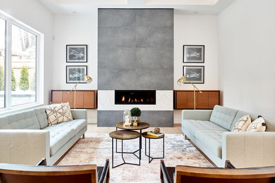 Trendy formal light wood floor living room photo in Vancouver with white walls, a ribbon fireplace, a stone fireplace and no tv